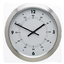 Aliminium wall clock with a groove rim around the clock that defines the clock, it has small lines in between the numbers to keep time and a big white face with big dials