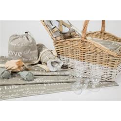 Natural wicker basket with cooler bag zip-style inside basket, lined with greige (grey/beige) colour French-style fabric. Included are 5 white melamine plates, 5 plastic wine glasses, 5 knives and forks and spoons, 1 bottle opener, and salt and pepper shaker. Cutlery and crockery are neatly strapped with leather-look straps. Table cloth, wine bottle bag and drawstring bag all in the same matching fabric. Attached to the basket is a beautiful large weather-proof picnic rug (1.8 m x 1.5 m) in the ....