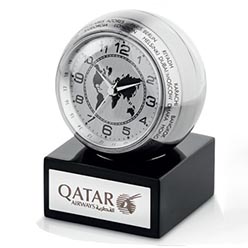 Heavy brushed metal, wooden base, turning world-time indicator, 1 x LR44 button cell battery included, includes metal branding plaque