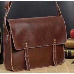 PU leather laptop bag with crossbody carry strap and front zippered compartment. Fits laptop up to 14