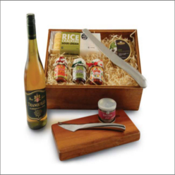re-useable wooden box, Blackwood cheese board, Turino cheese knife, capri bread knife, rice crackers, 3 preserves, 1 pate, 1 mints, bottle wine.